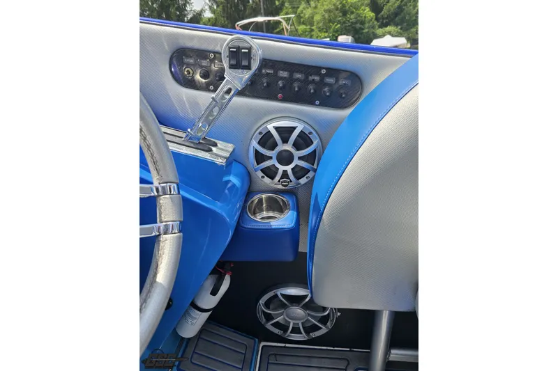 Slide: The Image of 2010 Nor-Tech 4300V boat dashboard with blue accents, speakers, and control panel. - 72