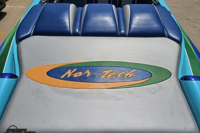 Slide: The Image of 2010 Nor-Tech 4300V boat with blue and gray seating, featuring the Nor-Tech logo. - 53