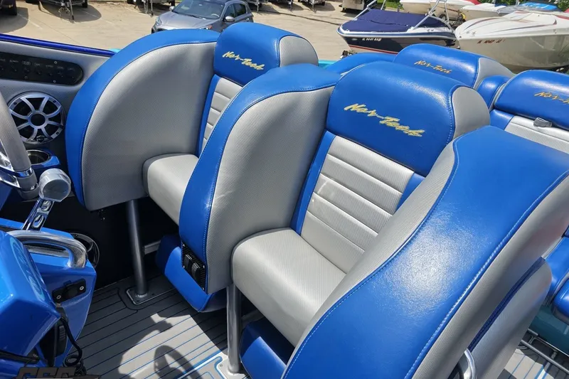 Slide: The Image of 2010 Nor-Tech 4300V boat interior with blue and gray seating, showcasing luxury design. - 69