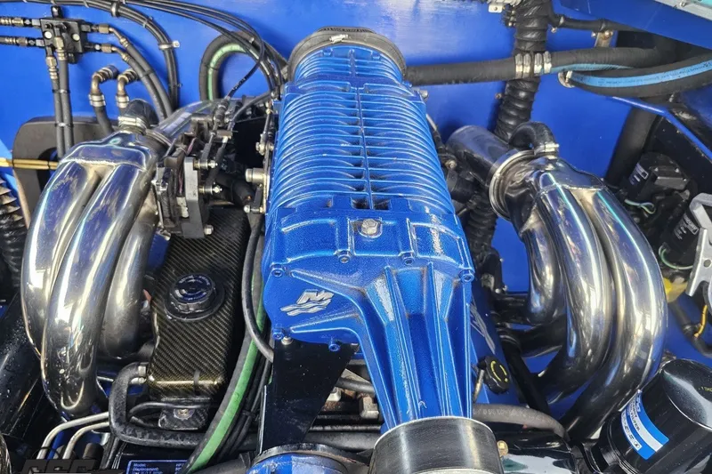 Slide: The Image of Engine of 2010 Nor-Tech 4300V with blue and chrome components. - 103