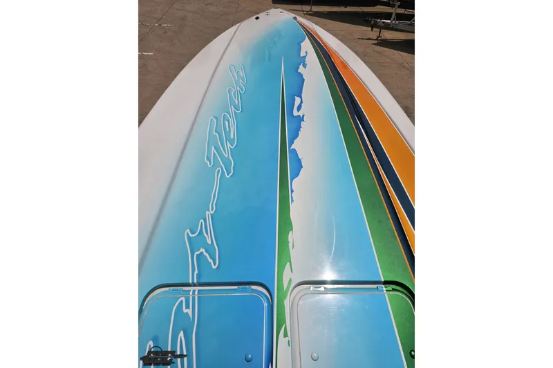 Slide: The Image of 2010 Nor-Tech 4300V boat with vibrant, colorful deck design. - 78