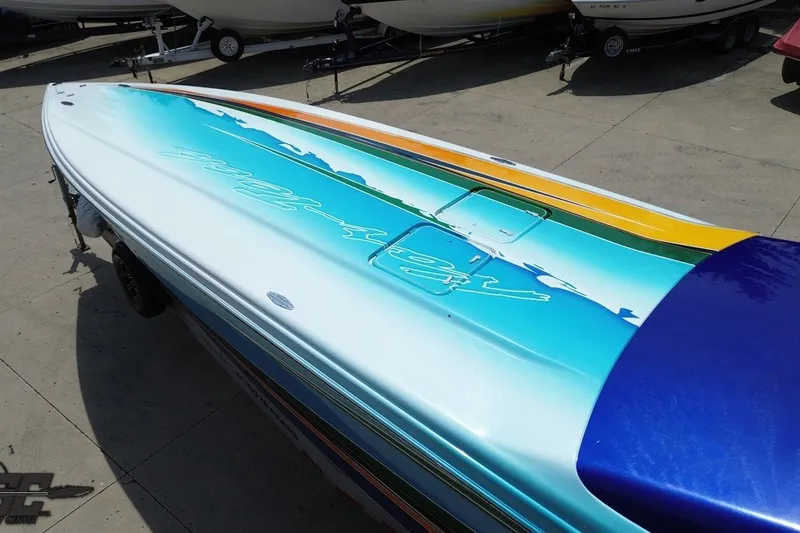 Slide: The Image of 2010 Nor-Tech 4300V boat with vibrant blue and yellow deck design. - 41