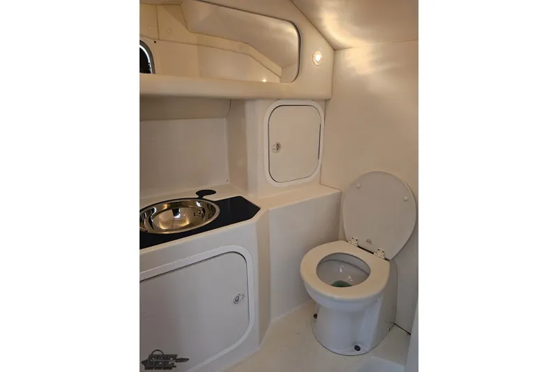 Slide: The Image of 2010 Nor-Tech 4300V boat bathroom with toilet, sink, and storage compartments. - 92