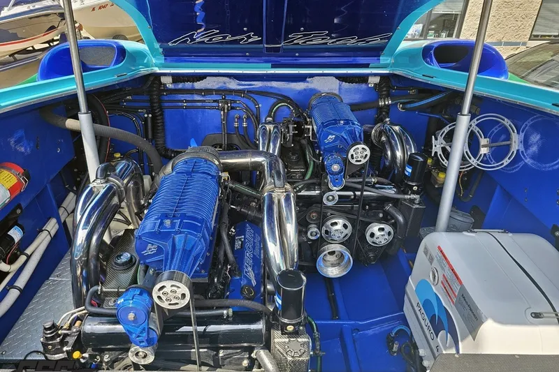 Slide: The Image of Engine compartment of a 2010 Nor-Tech 4300V boat, featuring dual Mercury engines. - 100