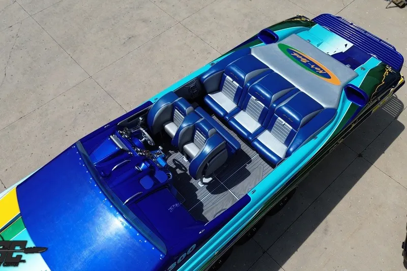 Slide: The Image of 2010 Nor-Tech 4300V boat with vibrant blue and teal seating, viewed from above. - 40