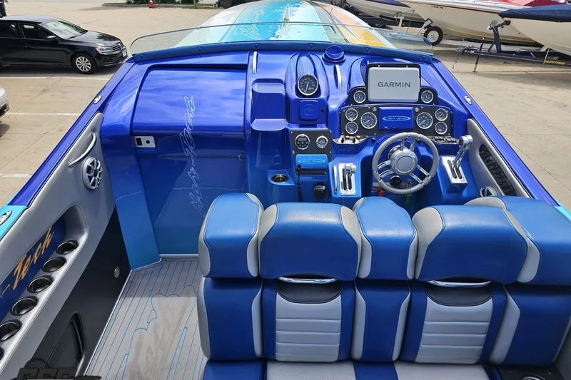 Slide: The Image of 2010 Nor-Tech 4300V boat cockpit with blue interior and advanced Garmin navigation system. - 59