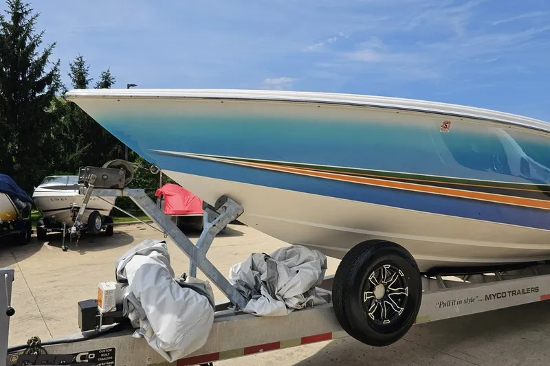 Slide: The Image of 2010 Nor-Tech 4300V boat on trailer, vibrant blue and orange design. - 22