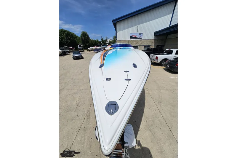 Slide: The Image of 2010 Nor-Tech 4300V boat with sleek design, parked outside a warehouse under clear skies. - 21