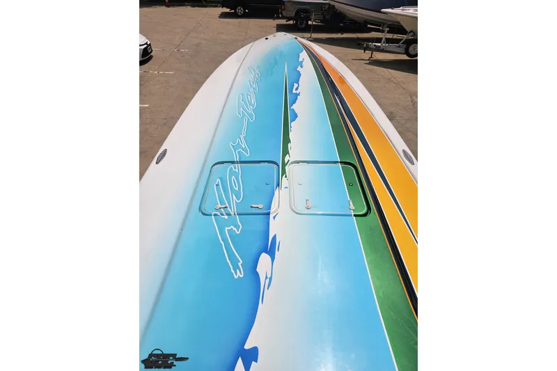 Slide: The Image of Colorful 2010 Nor-Tech 4300V boat deck with vibrant graphics and logo. - 77