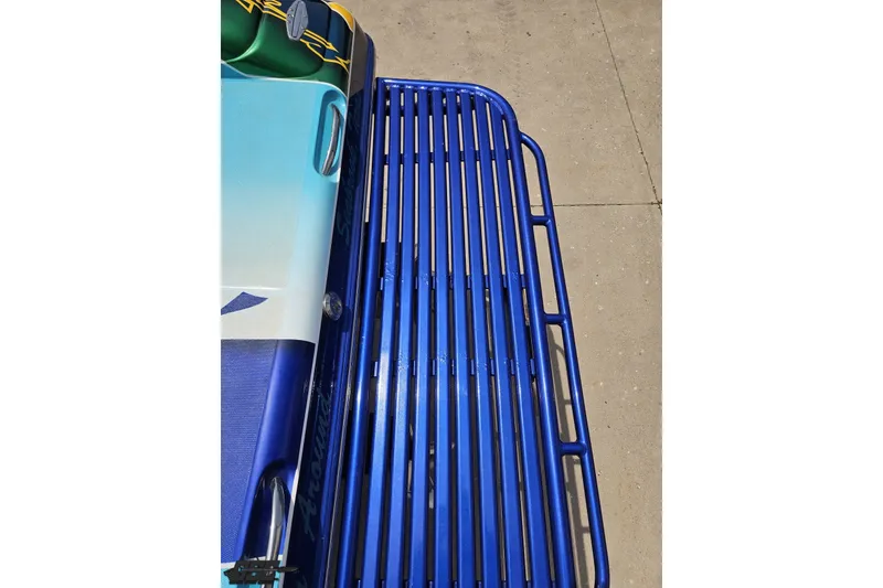 Slide: The Image of Close-up of a 2010 Nor-Tech 4300V boat with vibrant blue detailing. - 47