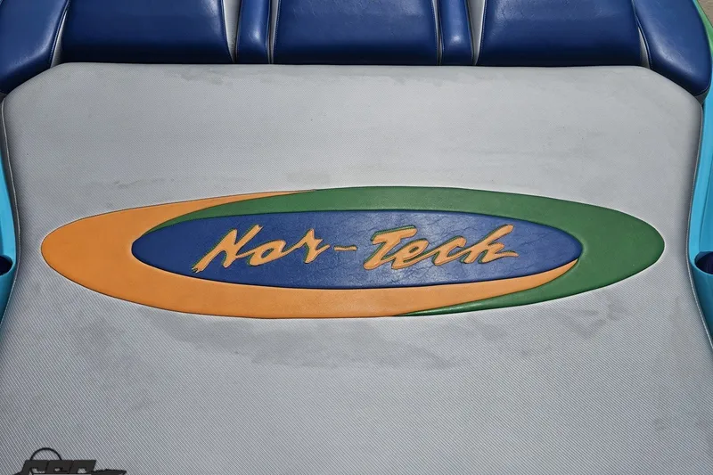 Slide: The Image of Nor-Tech 4300V 2010 boat seat with colorful logo design. - 54