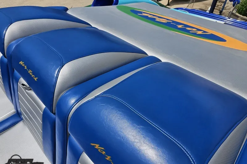 Slide: The Image of Blue and gray seating on 2010 Nor-Tech 4300V boat, featuring embroidered logo. - 62
