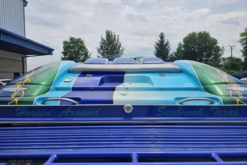 Slide: The Image of 2010 Nor-Tech 4300V boat with vibrant custom paint, labeled "Horsin' Around," Seabrook, Texas. - 36