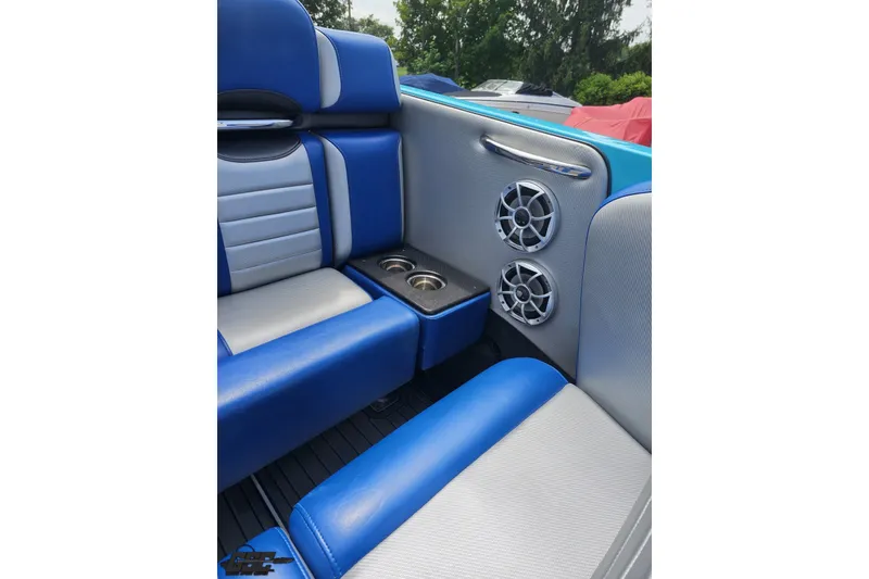 Slide: The Image of Blue and gray seating with cup holders and speakers in a 2010 Nor-Tech 4300V boat. - 65