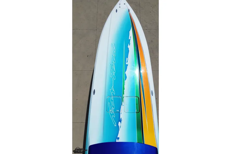 Slide: The Image of Top view of a 2010 Nor-Tech 4300V boat with vibrant blue and yellow design. - 44