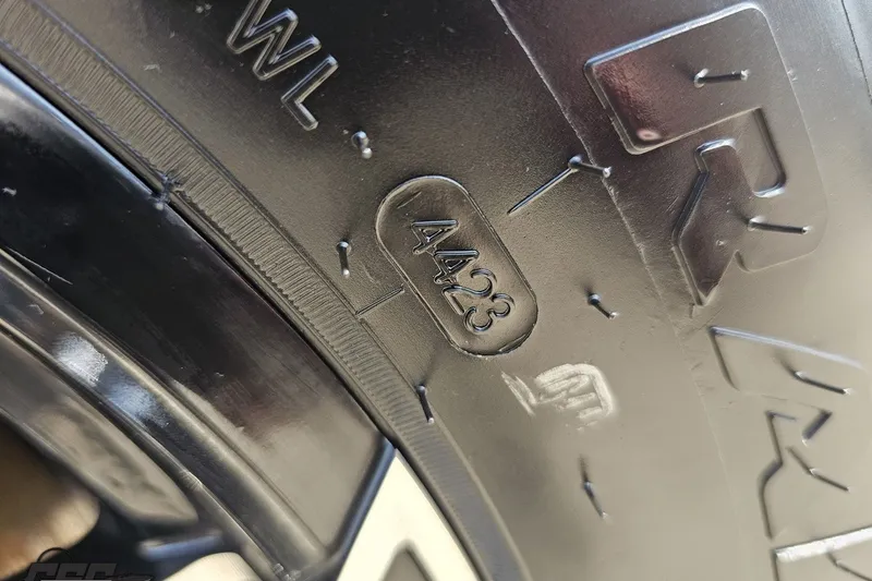 Slide: The Image of Close-up of a tire sidewall with embossed markings, including "4423" and "WL". - 107