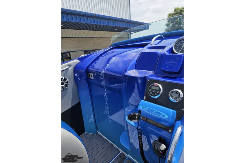 Slide: The Image of 2010 Nor-Tech 4300V boat dashboard with blue accents and control panel. - 74
