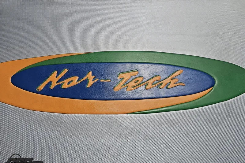 Slide: The Image of Nor-Tech 4300V 2010 logo with vibrant green, blue, and orange design. - 55