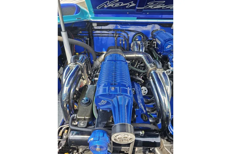 Slide: The Image of High-performance engine of a 2010 Nor-Tech 4300V boat, featuring blue and chrome components. - 102