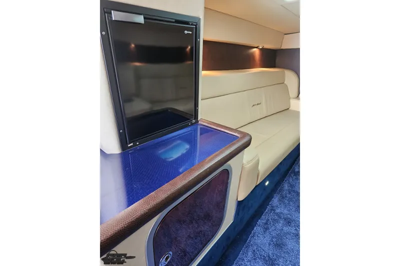 Slide: The Image of Luxurious interior of 2010 Nor-Tech 4300V boat with plush seating and sleek cabinetry. - 84