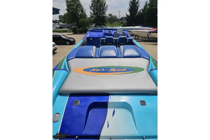Slide: The Image of 2010 Nor-Tech 4300V powerboat with blue seating and logo, parked outdoors. - 51