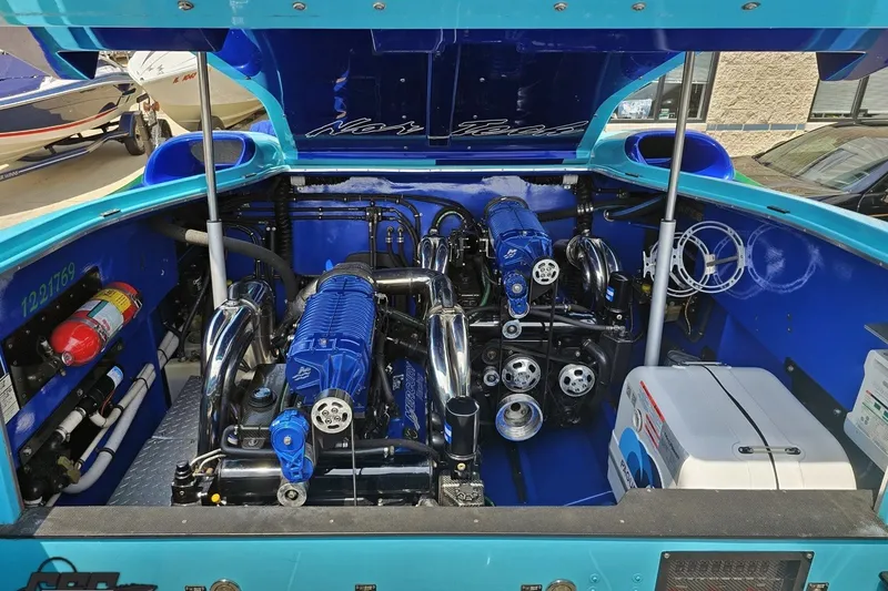 Slide: The Image of Engine compartment of a 2010 Nor-Tech 4300V boat, showcasing dual blue engines. - 99