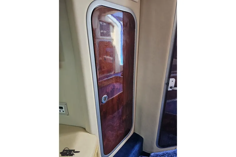 Slide: The Image of Interior cabin door of a 2010 Nor-Tech 4300V boat, featuring polished wood finish. - 89