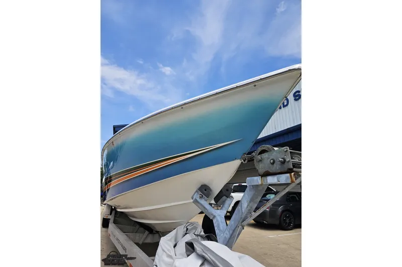 Slide: The Image of 2010 Nor-Tech 4300V boat on trailer, showcasing sleek hull design under blue sky. - 19
