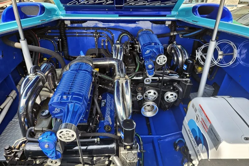Slide: The Image of Engine compartment of a 2010 Nor-Tech 4300V boat, featuring dual blue engines. - 101
