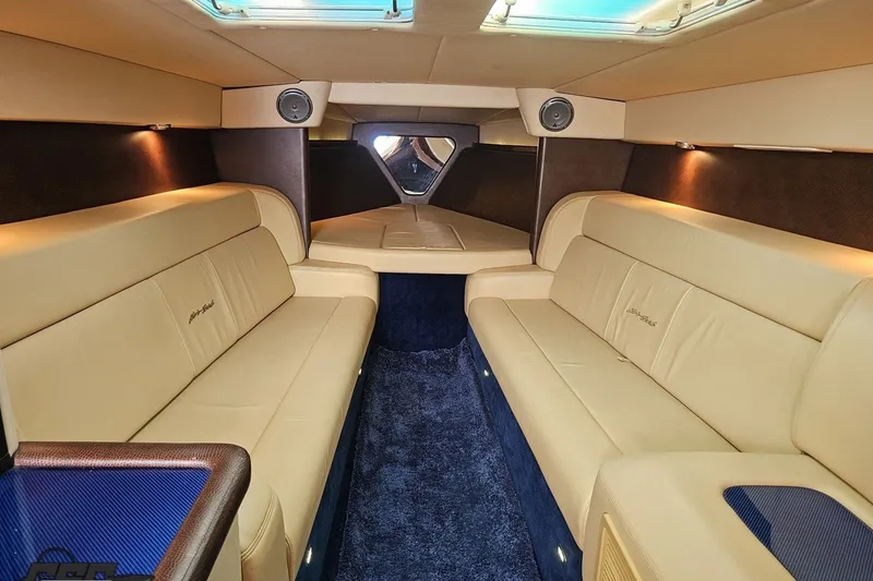 Slide: The Image of Luxurious interior of a 2010 Nor-Tech 4300V boat with beige leather seating. - 80