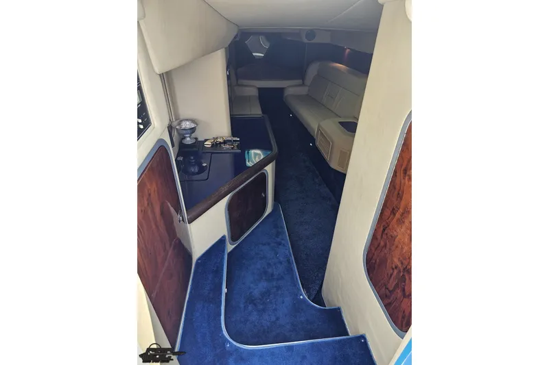 Slide: The Image of Luxurious interior of a 2010 Nor-Tech 4300V boat with blue carpet and beige seating. - 79
