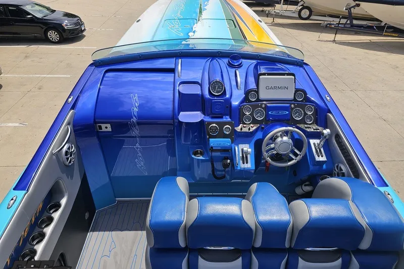 Slide: The Image of Cockpit of 2010 Nor-Tech 4300V boat with blue interior and Garmin navigation system. - 60