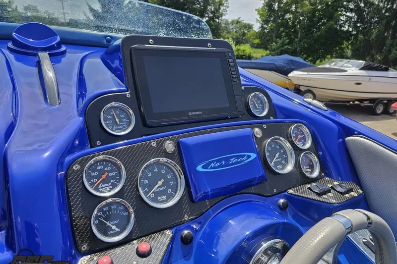 Slide: The Image of Dashboard of a 2010 Nor-Tech 4300V boat with gauges and Garmin display. - 70