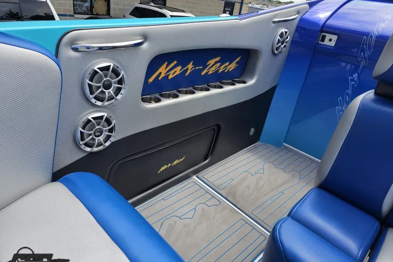 Slide: The Image of Interior of 2010 Nor-Tech 4300V boat with blue and gray seating and speakers. - 66