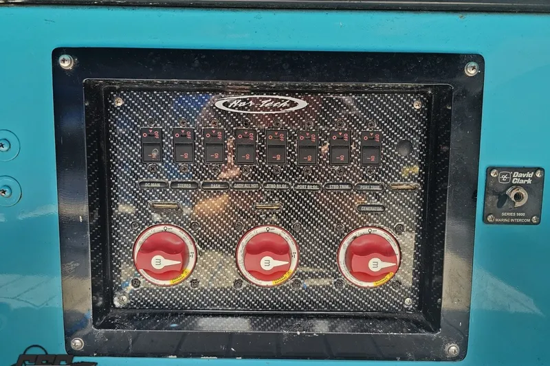Slide: The Image of Control panel of a 2010 Nor-Tech 4300V boat with switches and intercom. - 97