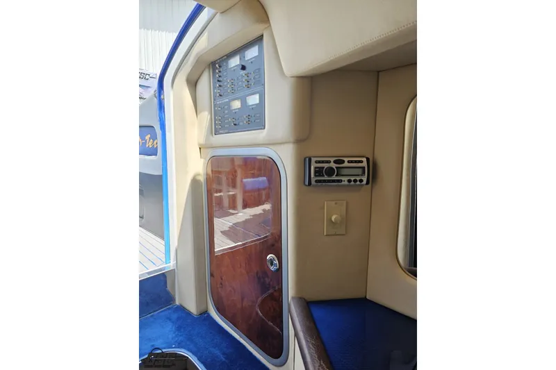 Slide: The Image of Interior view of a 2010 Nor-Tech 4300V boat, featuring control panels and wood accents. - 93