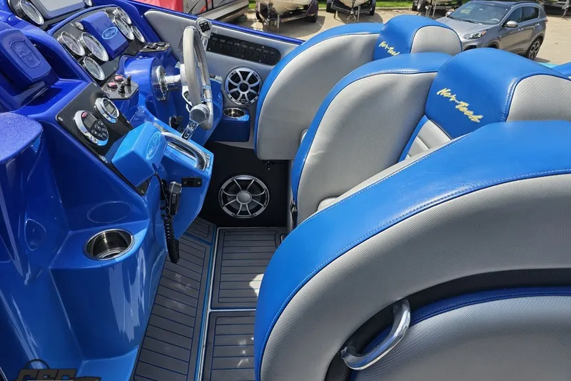 Slide: The Image of Interior of 2010 Nor-Tech 4300V boat with blue and gray seating and dashboard. - 68