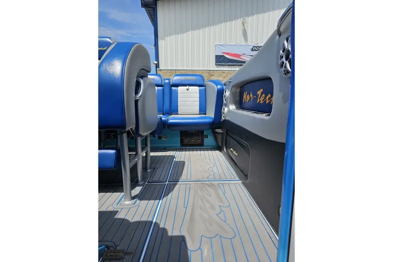 Slide: The Image of Interior of a 2010 Nor-Tech 4300V boat with blue seating and sleek design. - 95