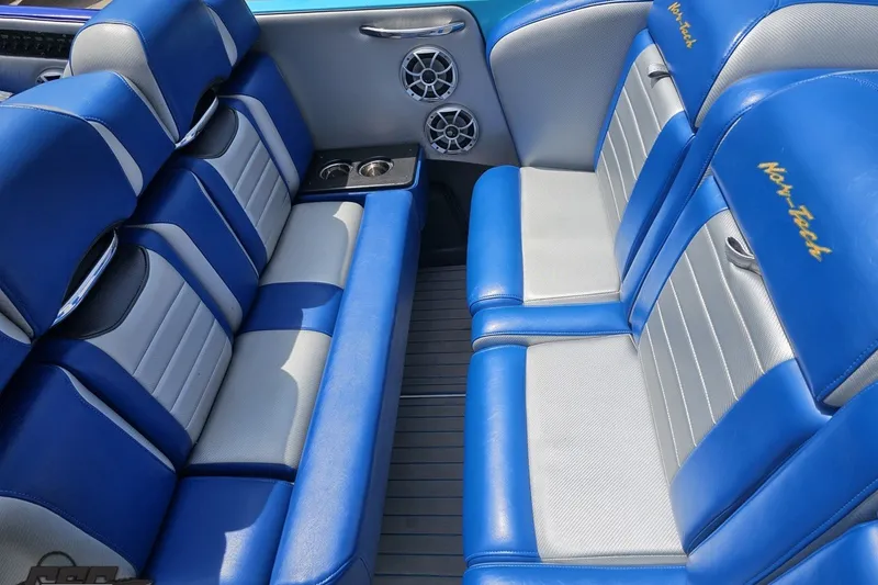 Slide: The Image of Luxurious blue and gray seating in a 2010 Nor-Tech 4300V boat interior. - 63