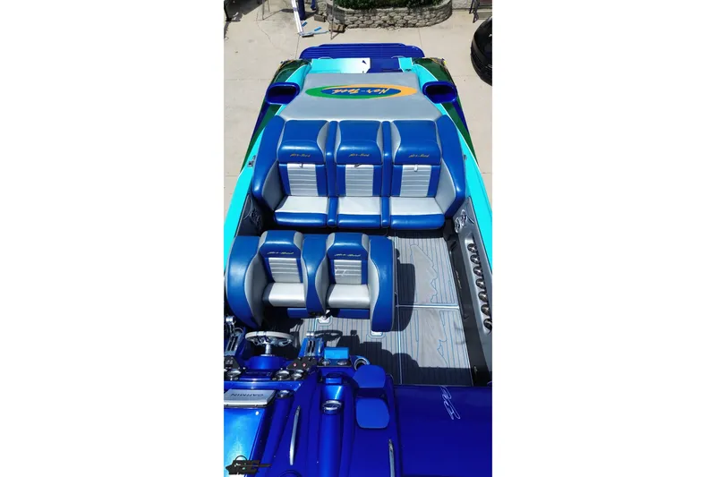 Slide: The Image of 2010 Nor-Tech 4300V boat interior with blue and gray seating, showcasing sleek design. - 46