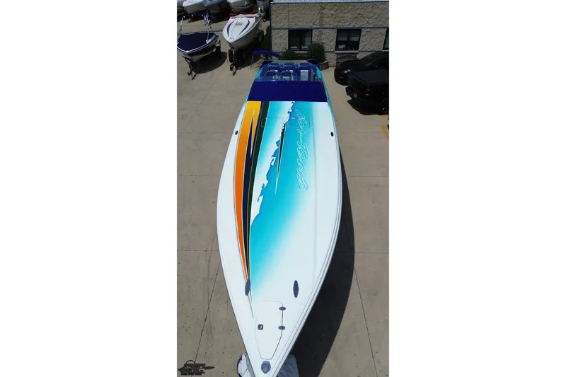 Slide: The Image of 2010 Nor-Tech 4300V boat with vibrant blue and orange design on deck. - 45