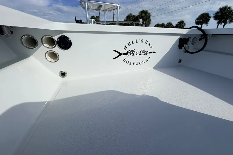 Slide: The Image of 2021 Hell's Bay Marathon boat interior with logo, featuring rod holders and sleek design. - 48