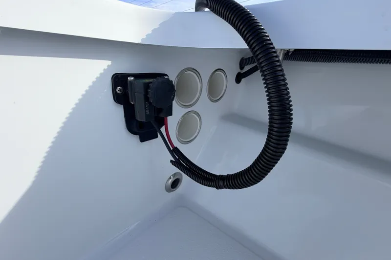 Slide: The Image of Interior view of a 2021 Hell's Bay Marathon boat, showcasing wiring and panel details. - 49