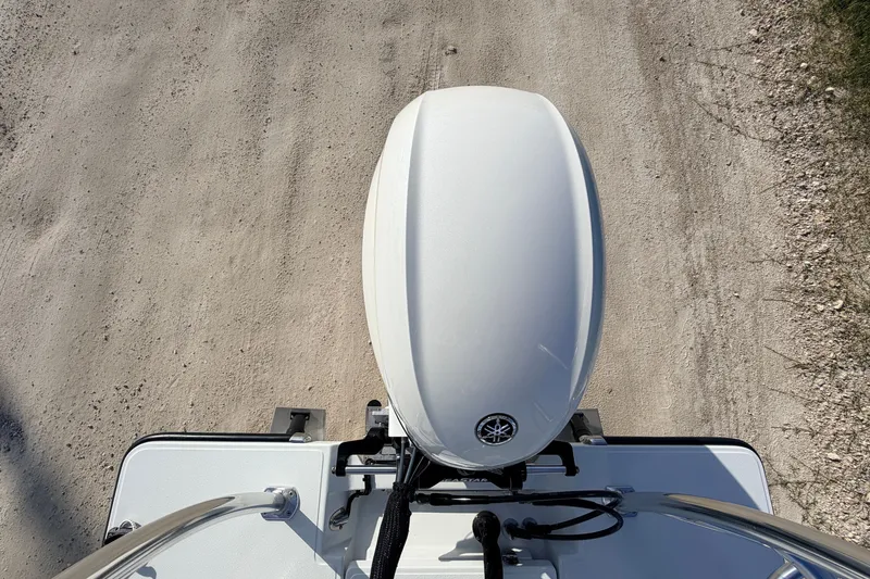 Slide: The Image of Top view of a 2021 Hell's Bay Marathon boat engine on a dirt road. - 82