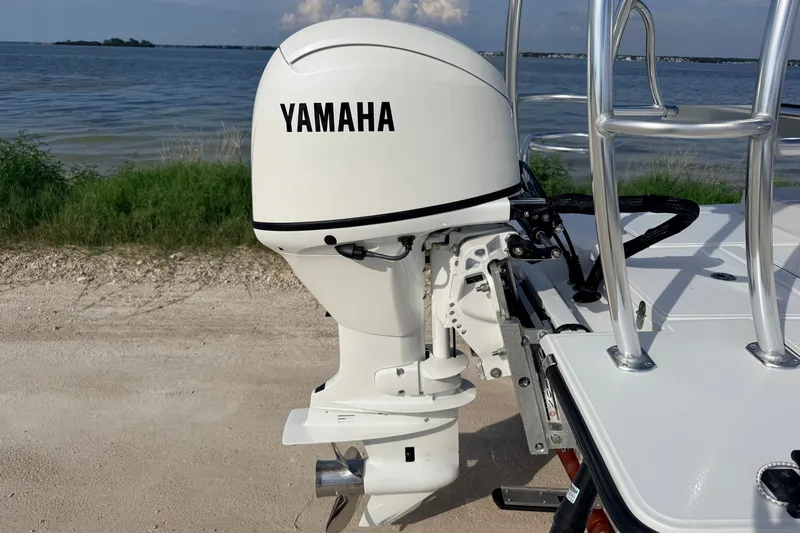 Slide: The Image of 2021 Hell's Bay Marathon boat with Yamaha outboard motor by the water. - 25