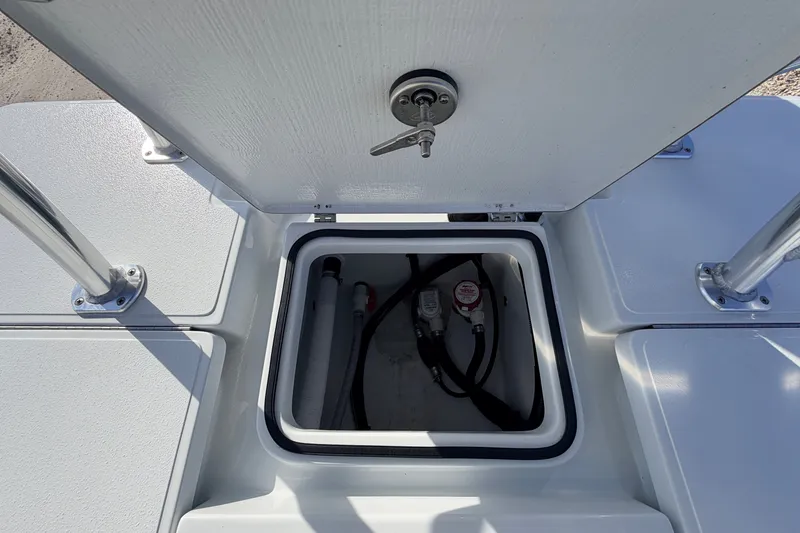 Slide: The Image of Open hatch on 2021 Hell's Bay Marathon boat, revealing interior components and wiring. - 75