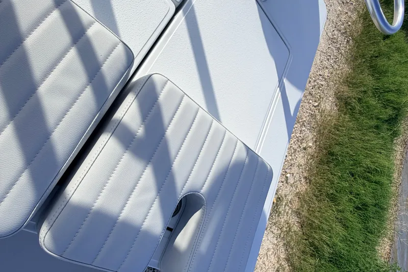 Slide: The Image of 2021 Hell's Bay Marathon boat interior with white cushioned seating and shadow patterns. - 72