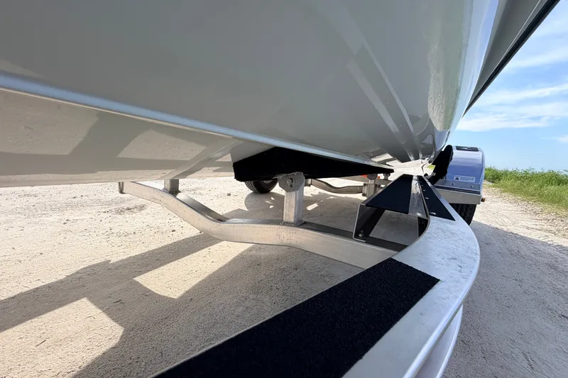 Slide: The Image of 2021 Hell's Bay Marathon boat on trailer, showcasing hull and trailer design. - 13