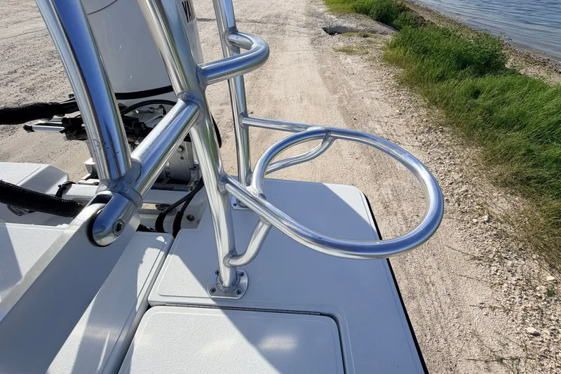 Slide: The Image of 2021 Hell's Bay Marathon boat with aluminum railing, parked near a shoreline. - 80