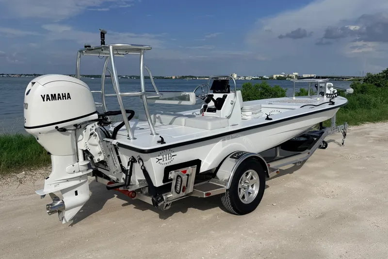The Image of 2021 Hell's Bay Marathon boat with Yamaha engine on a trailer by the water. - 0